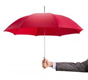 Businessman hand with an red umbrella isolated on white